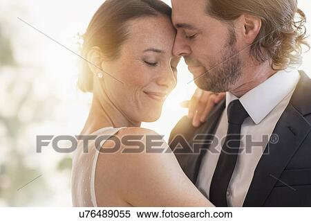 Stock Photography - Bride and groom dancing cheek to cheek. Fotosearch