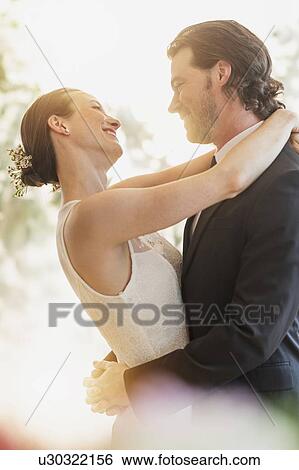 Stock Photograph - Bride and groom embracing. Fotosearch