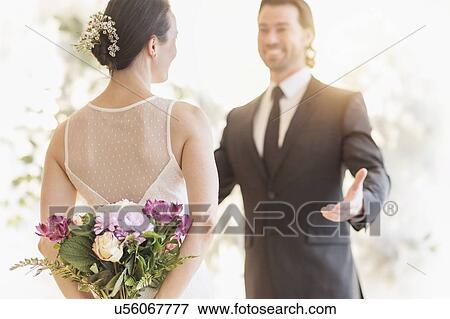 Stock Photo - Bride and groom looking at each other . Fotosearch
