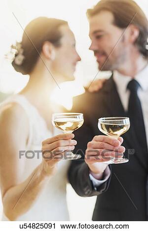 Bride and groom toasting with champagne View Large Photo Image Stock Image - Bride and groom toasting with champagne. Fotosearch
