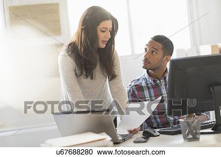 Business couple working in office View Large Photo Image Stock Image - Business couple working in office. Fotosearch