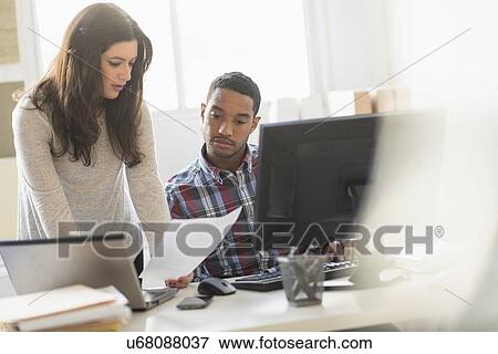 Stock Photo - Business couple working in office. Fotosearch