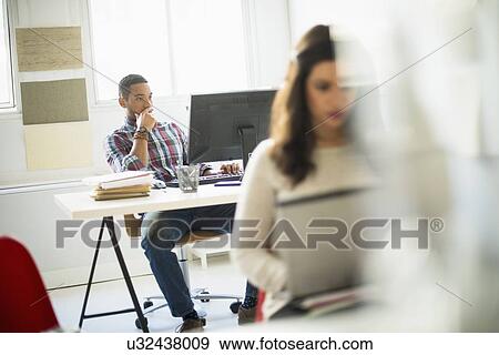 Stock Photo - Businessman concentrating in office. Fotosearch