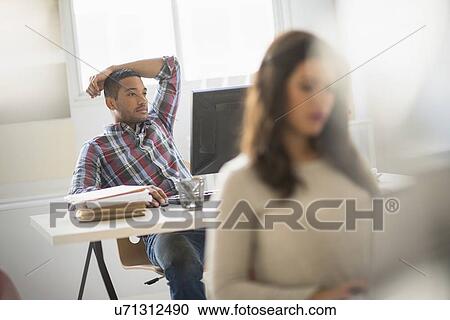 Businessman relaxing in office View Large Photo Image Stock Image - Businessman relaxing in office. Fotosearch