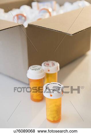 Stock Photo - Cardboard box and medicine containers. Fotosearch