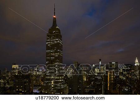 Stock Image - Cityscape with Empire State Building at night. Fotosearch