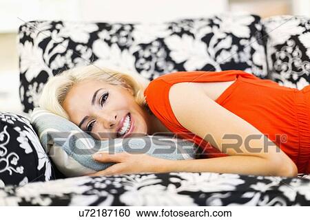 Close-up of woman lying down on sofa and smiling to camera View Large Photo Image Stock Image - Close-up of woman lying down on sofa and smiling to camera. Fotosearch