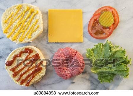 Stock Photo - Close-up shot of hamburger ingredients in rows on table. Fotosearch