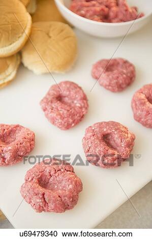 Close-up shot of meatballs in row on white cutting board View Large Photo Image Stock Image - Close-up shot of meatballs in row on white cutting board. Fotosearch