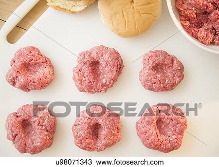 Close-up shot of meatballs in row on white cutting board View Large Photo Image Stock Image - Close-up shot of meatballs in row on white cutting board. Fotosearch