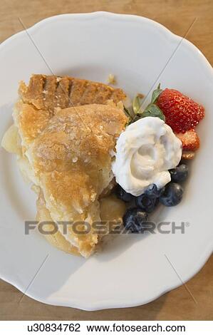 Close-up shot of portion of apple pie with fresh berries and cream on white plate View Large Photo Image Stock Image - Close-up shot of portion of apple pie with fresh berries and cream on white plate. Fotosearch
