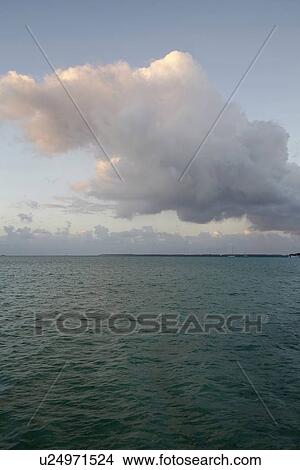 Cloudy sky above calm sea View Large Photo Image Picture - Cloudy sky above calm sea. Fotosearch