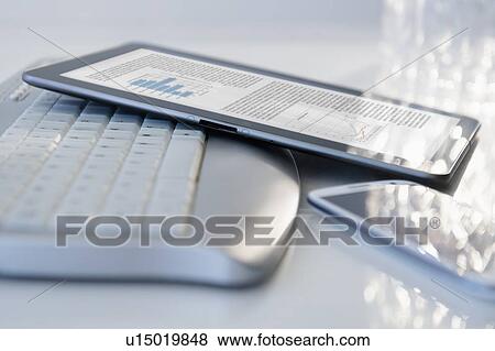 Stock Photo - Computer keyboard, smart phone and digital tablet. Fotosearch