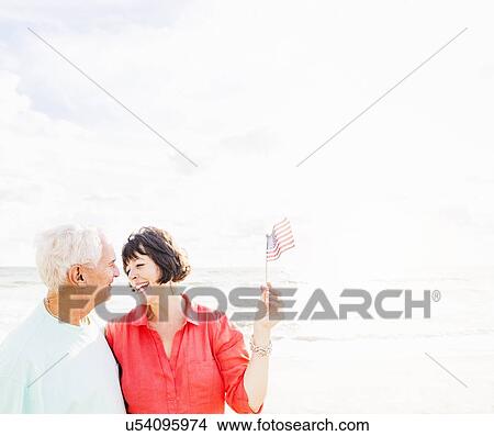 Couple celebrating Fourth of July on beach View Large Photo Image Picture - Couple celebrating Fourth of July on beach. Fotosearch