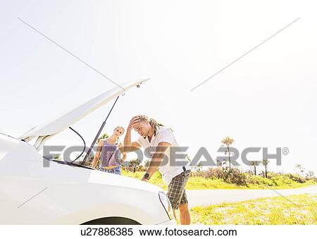 Couple checking car engine View Large Photo Image Stock Photography - Couple checking car engine. Fotosearch