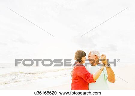 Couple dancing on beach at sunrise View Large Photo Image Stock Image - Couple dancing on beach at sunrise. Fotosearch