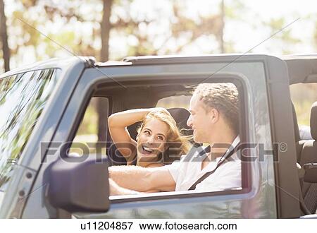 Couple in car View Large Photo Image Stock Photo - Couple in car. Fotosearch