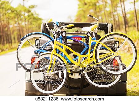 Couple in car with bike rack View Large Photo Image Stock Photograph - Couple in car with bike rack. Fotosearch
