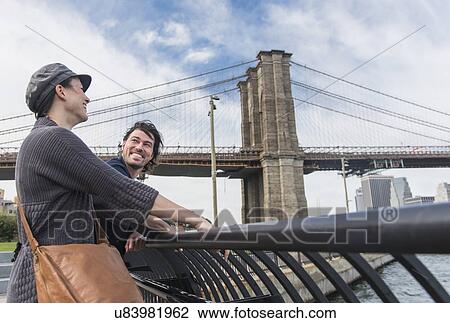Couple leaning against railing View Large Photo Image Stock Image - Couple leaning against railing . Fotosearch