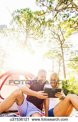 Stock Image - Couple looking at digital tablet. Fotosearch