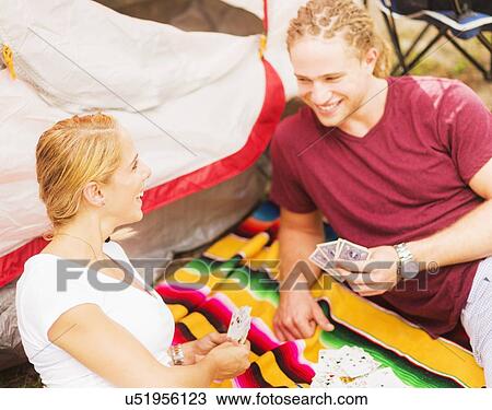 Couple playing cards in front of tent View Large Photo Image Stock Image - Couple playing cards in front of tent. Fotosearch