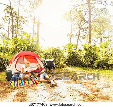 Couple playing cards in front of tent View Large Photo Image Stock Image - Couple playing cards in front of tent. Fotosearch