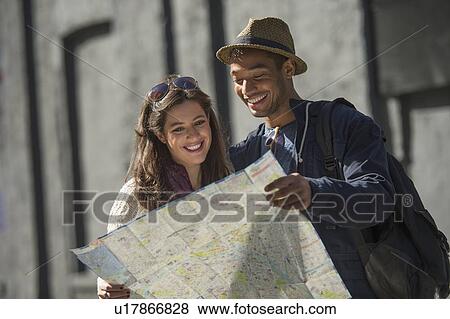 Couple reading map on street View Large Photo Image Stock Photo - Couple reading map on street. Fotosearch