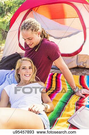 Couple resting in front of tent View Large Photo Image Stock Image - Couple resting in front of tent. Fotosearch