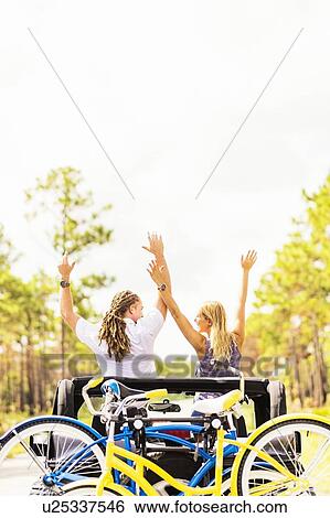 Couple rising hands in car View Large Photo Image Stock Photograph - Couple rising hands in car. Fotosearch