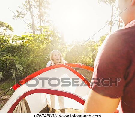 Couple setting up tent in forest View Large Photo Image Stock Image - Couple setting up tent in forest. Fotosearch
