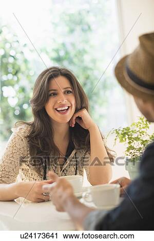 Couple sitting at table View Large Photo Image Stock Image - Couple sitting at table. Fotosearch