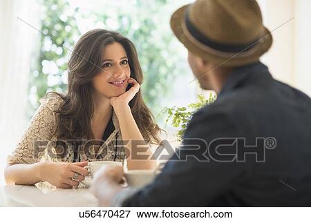 Couple sitting at table View Large Photo Image Stock Photo - Couple sitting at table. Fotosearch