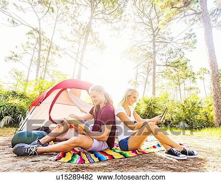 Couple sitting in front of tent View Large Photo Image Stock Image - Couple sitting in front of tent. Fotosearch