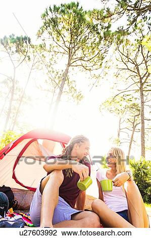 Couple sitting with coffee in front of tent View Large Photo Image Stock Image - Couple sitting with coffee in front of tent. Fotosearch