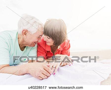 Stock Photo - Couple spending time together on beach. Fotosearch