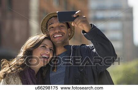 Couple taking selfie on street View Large Photo Image Stock Photography - Couple taking selfie on street . Fotosearch