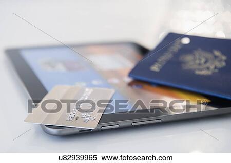 Stock Photography - Credit card, passport and digital tablet. Fotosearch