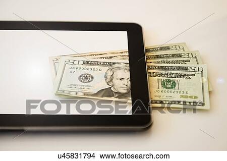 Digital tablet and twenty dollar bills View Large Photo Image Picture - Digital tablet and twenty dollar bills. Fotosearch