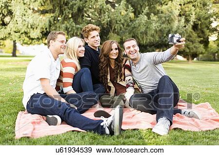 Friends taking selfie in park View Large Photo Image Stock Photo - Friends taking selfie in park. Fotosearch
