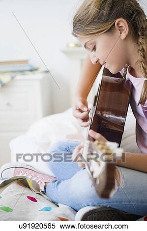 Girl (12-13) playing guitar View Large Photo Image Stock Photography - Girl (12-13) playing guitar. Fotosearch