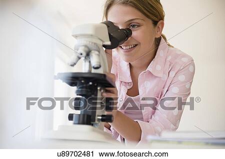 Girl (12-13) using microscope View Large Photo Image Stock Image - Girl (12-13) using microscope. Fotosearch