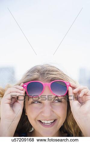 Girl (12-13) with pink sunglasses View Large Photo Image Stock Photo - Girl (12-13) with pink sunglasses. Fotosearch