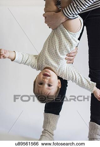 Stock Photograph - Girl (12-17 months) playing with her mom. Fotosearch