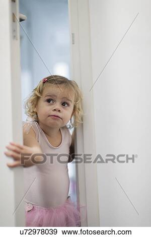 Girl (2-3) in pink skirt opening bedroom door View Large Photo Image Stock Photo - Girl (2-3) in pink skirt opening bedroom door. Fotosearch