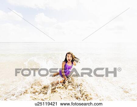 Girl (6-7) having fun in water View Large Photo Image Stock Image - Girl (6-7) having fun in water. Fotosearch