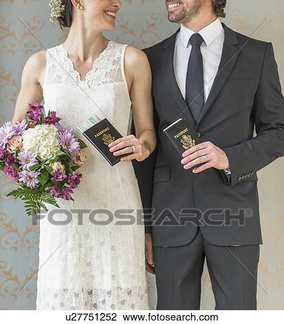 Happy bride and groom posing with passports View Large Photo Image Stock Image - Happy bride and groom posing with passports. Fotosearch