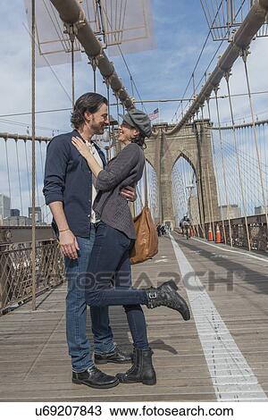 Happy couple embracing on Brooklyn Bridge View Large Photo Image Stock Image - Happy couple embracing on Brooklyn Bridge . Fotosearch