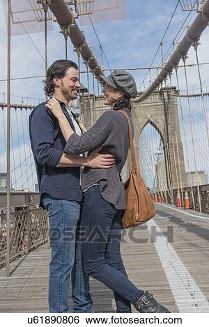 Happy couple embracing on Brooklyn Bridge View Large Photo Image Stock Photograph - Happy couple embracing on Brooklyn Bridge . Fotosearch