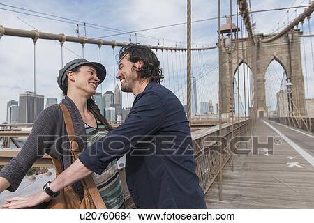 Happy couple flirting on Brooklyn Bridge View Large Photo Image Picture - Happy couple flirting on Brooklyn Bridge . Fotosearch