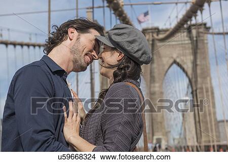 Happy couple kissing on Brooklyn Bridge View Large Photo Image Picture - Happy couple kissing on Brooklyn Bridge . Fotosearch